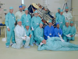 An international AMSAT team (from 6 of the 14 countries involved in the project) pose in their "bunny suits" in the ArianeSpace clean room facility in Kourou, French Guiana. The satellite is AMSAT's Phase 3-D which later became AMSAT OSCAR 40 on orbit.