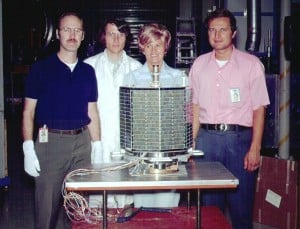 Members of the AO-7 project team pose with the fruits of their labor. From left are Dick Daniels, W4PUJ (SK); Jan King, W3GEY; "hired hand" Marie Marr and AMSAT Founding President Perry Klein, W3PK